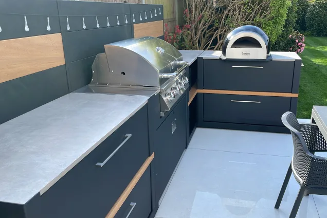 Outdoor kitchen in Hertford with bull bbq and pizza oven and storage and worktop space