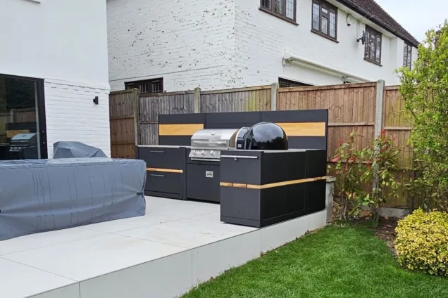 Outdoor kitchen in Hertford with bull bbq and pizza oven and covered table