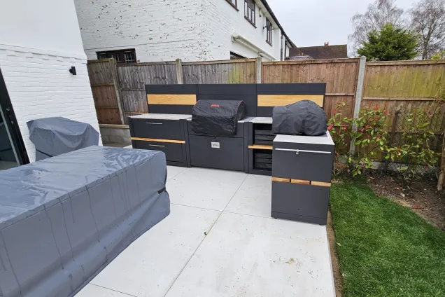 Outdoor kitchen in Hertford with bull bbq and pizza oven with covers on