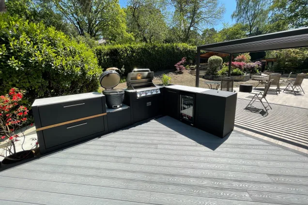 Outdoor kitchen in Hampshire on decking with gas and charcoal bbqs and fridge