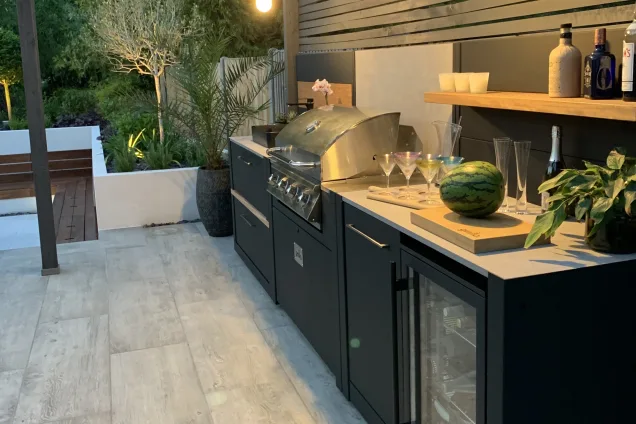 Outdoor kitchen in sussex on decking with integrated fridge and bin