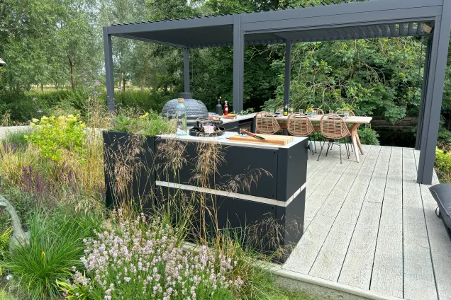 outdoor kitchen in Kelvedon with outdoor eating area on decking with lots of plants