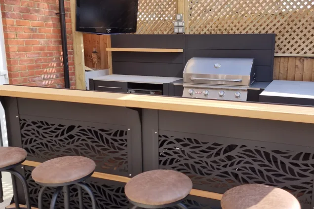 Outdoor kitchen in Kempston with stools at bar cabinets