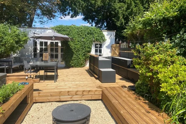 Outdoor kitchen in bristol on wooden decking with bar cabinets and storage cabinets