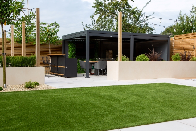 Outdoor kitchen in Leicestershire under pergola in landscaped garden