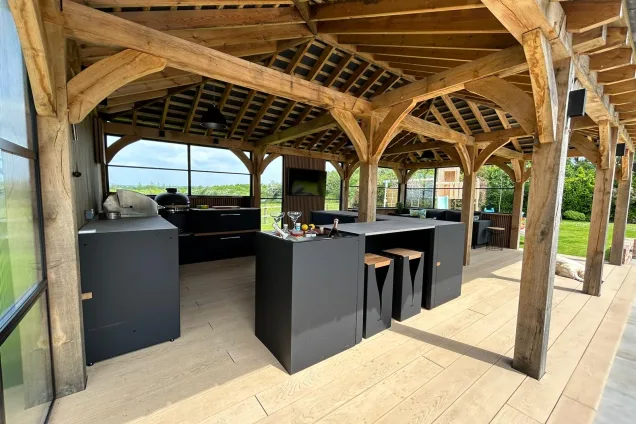 Outdoor kitchen in Hertfordshire with drinks station under wooden cover