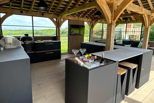 Outdoor kitchen in Hertfordshire with drinks station and bar table and stools