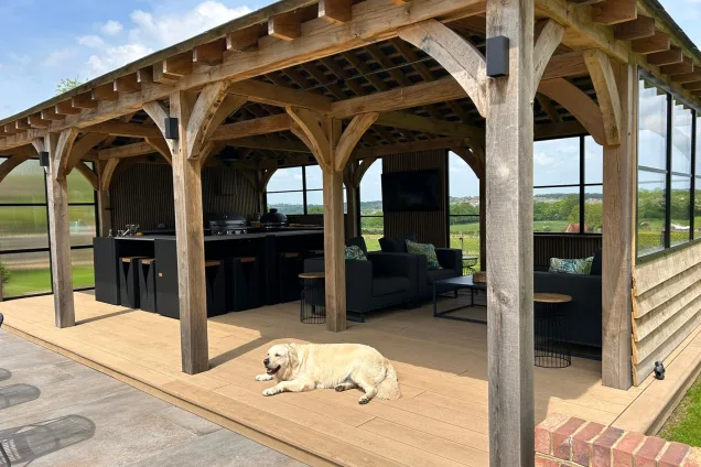 Outdoor kitchen in Hertfordshire with dog laying in front of kitchen