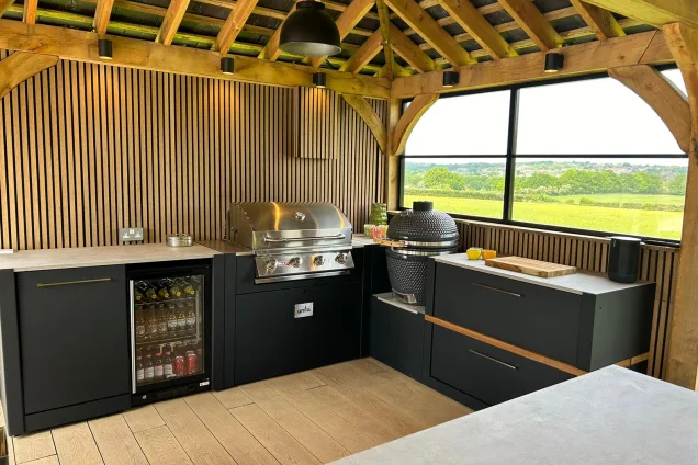 Outdoor kitchen in Hertfordshire with Gas BBQ, Gusto BBQ and fridge cabinet and storage units and worktop space