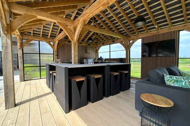 Outdoor kitchen in Hertfordshire with Bar table and stools and seating area