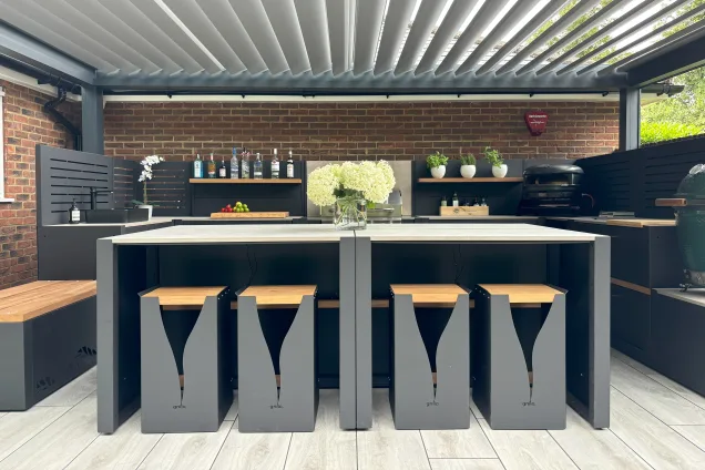 Outdoor kitchen in Hertfordshire with island made of bar table and stools