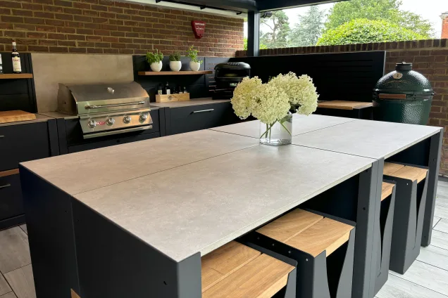 Outdoor kitchen in Hertfordshire with flowers on island and bull gas bbq and pizza oven