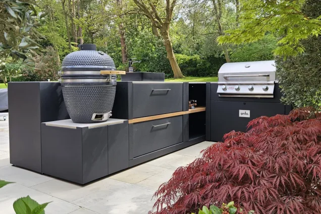 Outdoor kitchen in Weybridge with Gas BBQ, Charcoal bbq and bar stools on patio