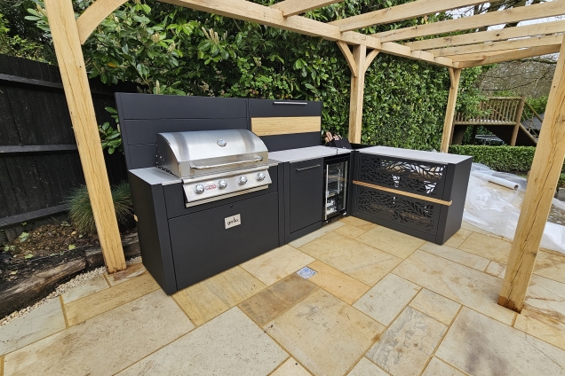 Outdoor kitchen in Welwyn Garden City with Bull bbq, drinks fridge and bar cabinet and stools