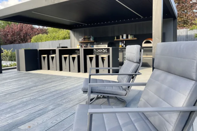 Outdoor kitchen in Bedfordshire with deck chairs