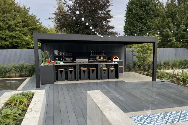 Outdoor kitchen in Bedfordshire with Bull BBQ and bar table and stools