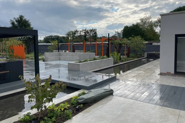 Outdoor kitchen in Bedfordshire with stone planters in the garden