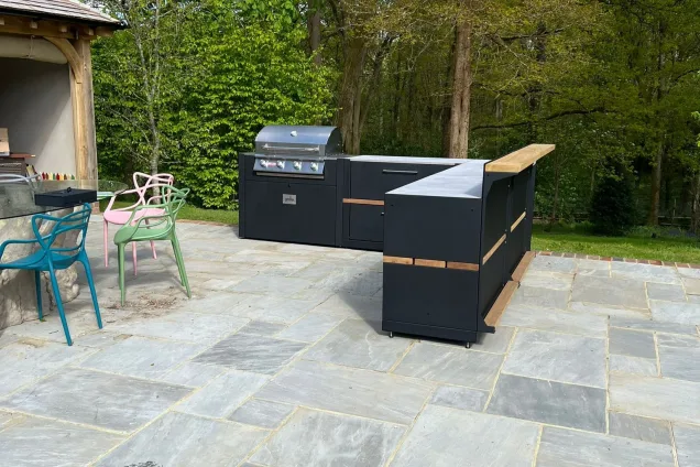 Outdoor kitchen in Cranleigh on patio in wooded garden with Bull gas bbq and bar cabinets