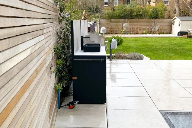 Outdoor kitchen in ealing on white patio with Bull bbq and sink