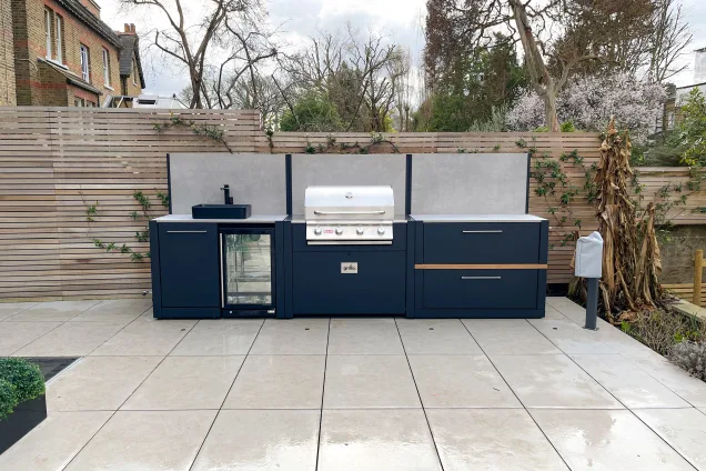 Outdoor kitchen in ealing on white patio with Bull bbq and worktop and storage space