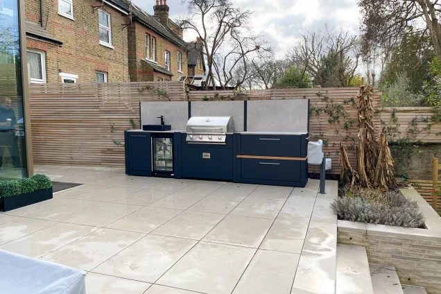 Outdoor kitchen in ealing on white patio with Bull bbq and worktop space