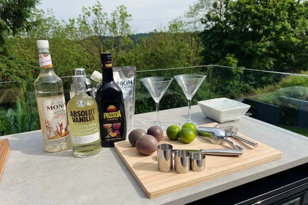 Outdoor kitchen in Wrexham with ingredients for cocktails on worktop.