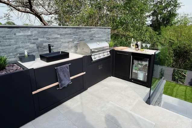 Outdoor kitchen in Wrexham with sink, bull gas bbq and fridge and bin unit