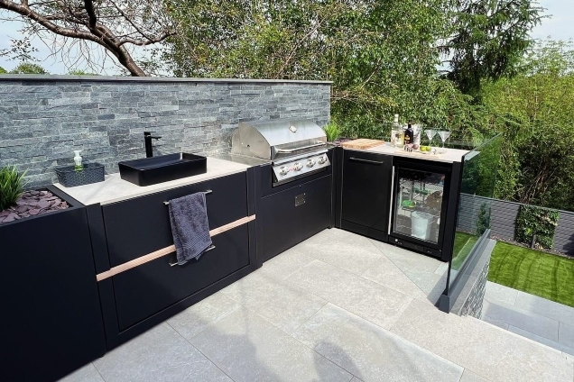Outdoor kitchen in Wrexham with sink, bull gas bbq and fridge and bin unit on patio
