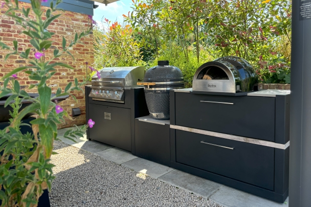 Outdoor kitchen in saffron walden with Gas bbq, charcoal bbq and pizza oven on storage units