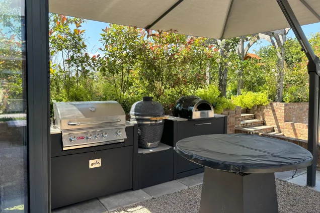 Outdoor kitchen in saffron walden under canopy with chefs anvil, gas bbq, charcoal bbq and pizza oven
