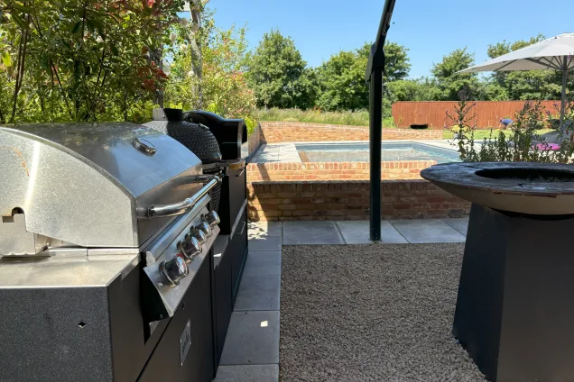 Outdoor kitchen in saffron walden under canopy with Gas bbq