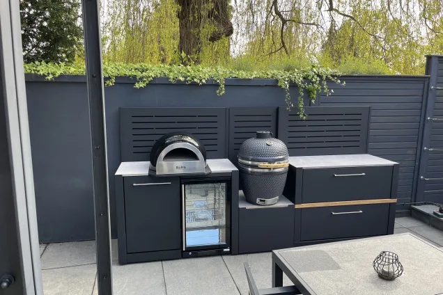 outdoor kitchen with wood-fired pizza oven, built-in fridge and Gusto charcoal BBQ in St Albans, Hertfordshire