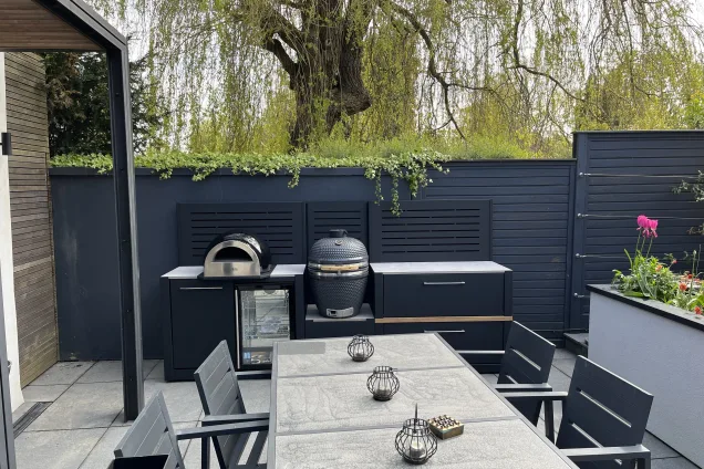 outdoor kitchen on patio next to tall black fence in St Albans, Hertfordshire