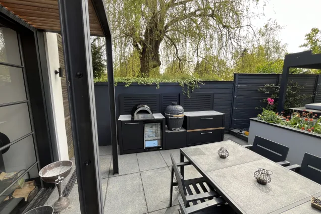 straight outdoor kitchen on patio with large dining area and Gusto charcoal BBQ in St Albans, Hertfordshire