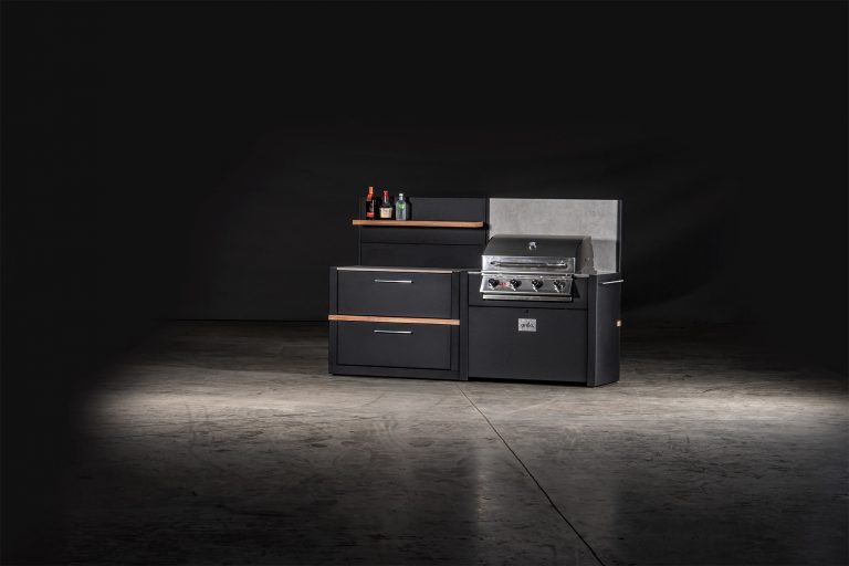 outdoor kitchen with storage cabinet and feature wall and the bull gas grill station