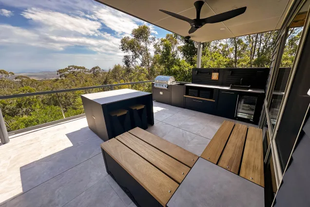 outdoor kitchen on veranda with seating and bull gas grill station