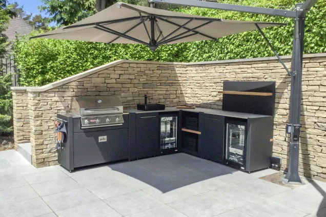 outdoor kitchen with gas grill station, sink, two drinks fridge and bins