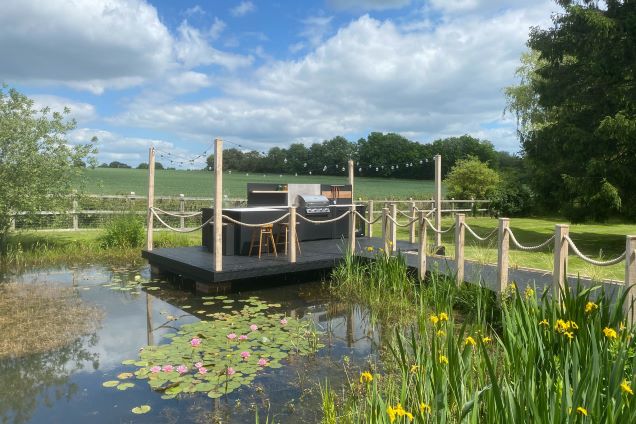 outdoor kitchen on pontoon over small pond