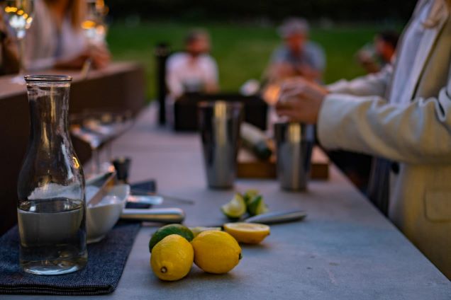 person making cocktails on grillo bar table