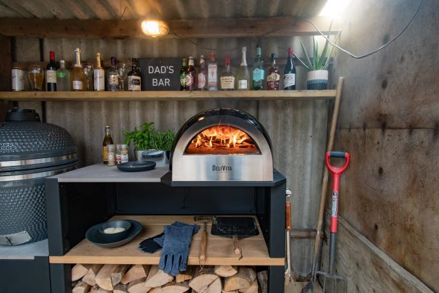 outdoor kitchen with gusto charcoal bbq and wood fired pizza oven