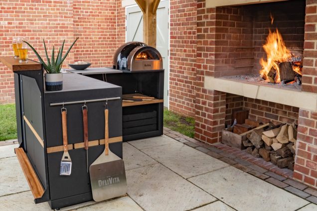 outdoor kitchen on patio with pizza oven and fire