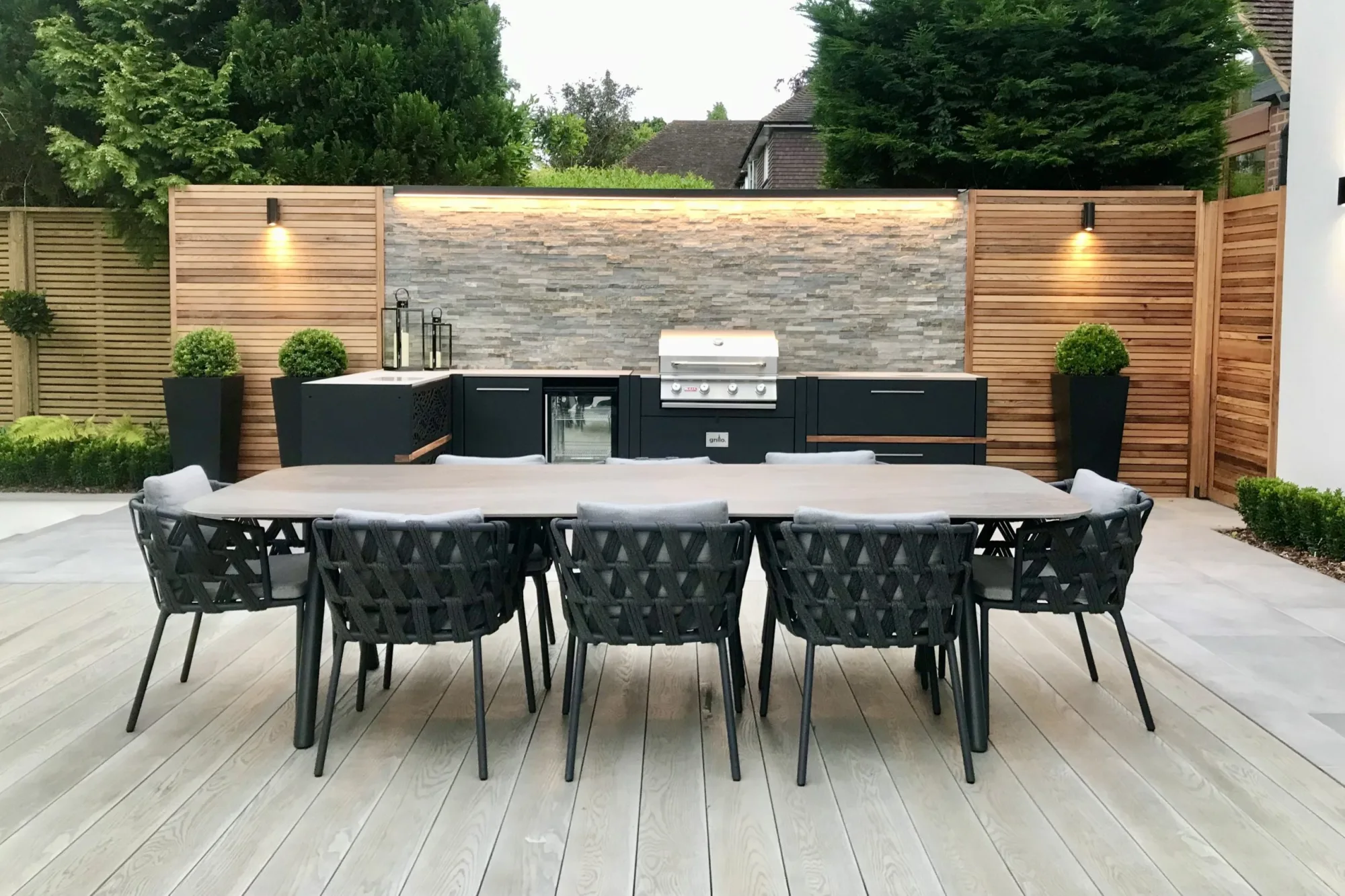 outdoor kitchen in kent on decking with large outdoor table and seating