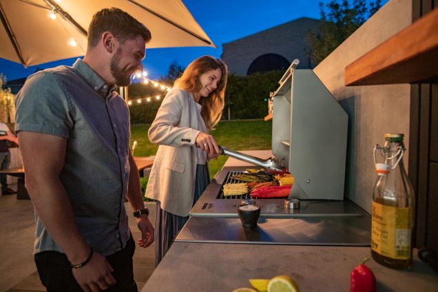 people cooking on electric bbq in outdoor kitchen