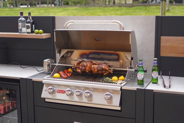 bull angus gas grill station with chicken on the rotisserie and veg on grill