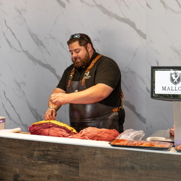 Mike Malloy in his butcher shot tying meat up