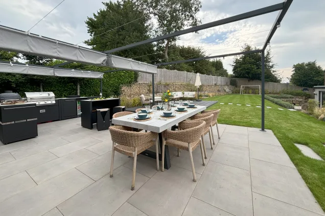 grillo kitchen with dining table under pergola on patio