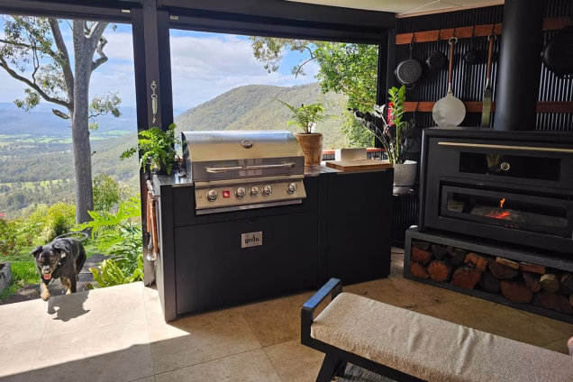 outdoor kitchen area with fireplace in Hunter Valley with hot tub and mountain view