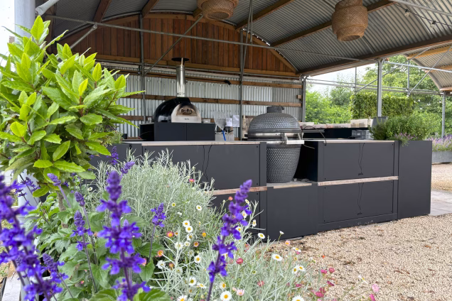 outdoor kitchen cafe with BBQ and purple flowers