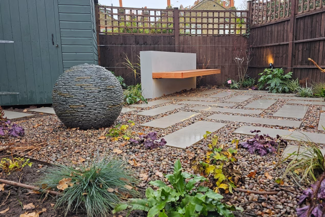 Dulwich garden with bench in corner next to outdoor kitchen