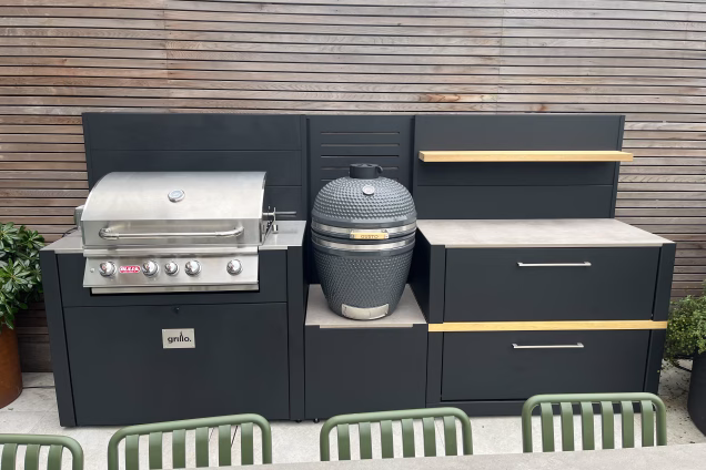 Outdoor kitchen in hammersmith with bull gas bbq, gusto charcoal bbq and storage cabinet with doors